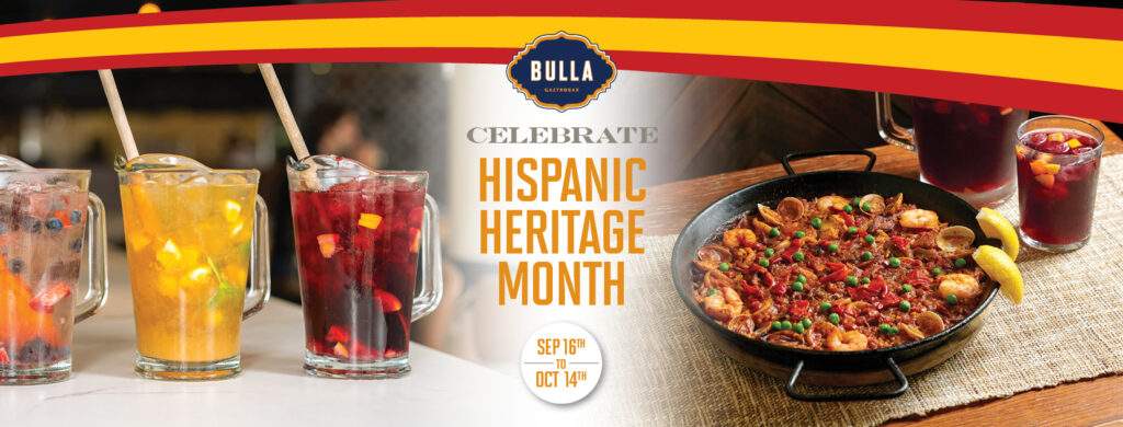 Seafood paella and sangría pitchers at Bulla Gastrobar, celebrating Hispanic Heritage Month with the best Spanish restaurant experience.