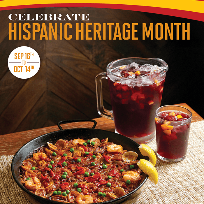Seafood paella and sangría pitchers at Bulla Gastrobar, celebrating Hispanic Heritage Month with the best Spanish restaurant experience.