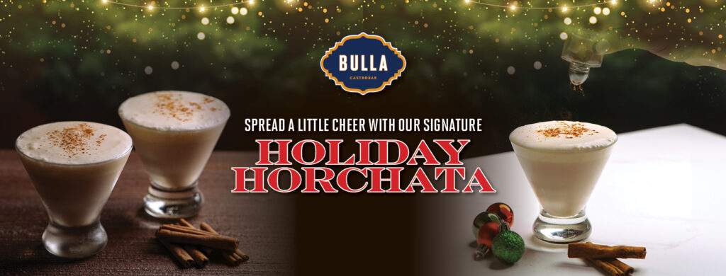 A festive glass of Holiday Horchata from Bulla Gastrobar topped with cinnamon, served in a cozy holiday setting."
