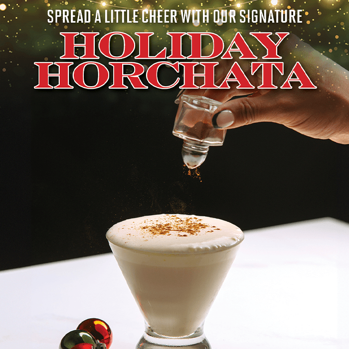 Spiced Holiday Horchata from Bulla Gastrobar, a festive creamy drink topped with cinnamon, perfect for celebrating the holiday season.