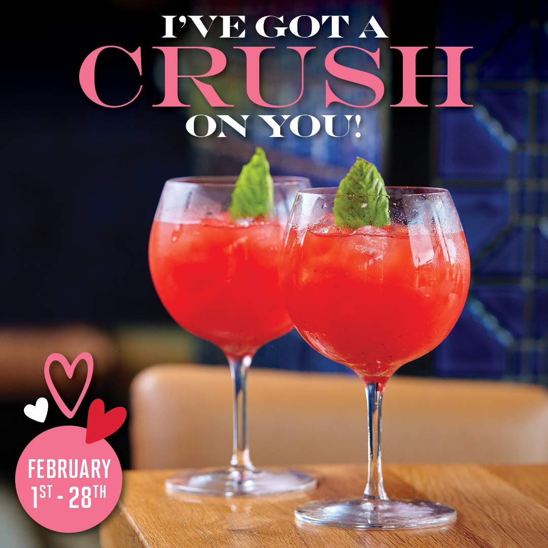 Two bright pink Strawberry Crush Valentine’s Day cocktails garnished with fresh mint, featured at Bulla Gastrobar with a February 1–28 promotion.