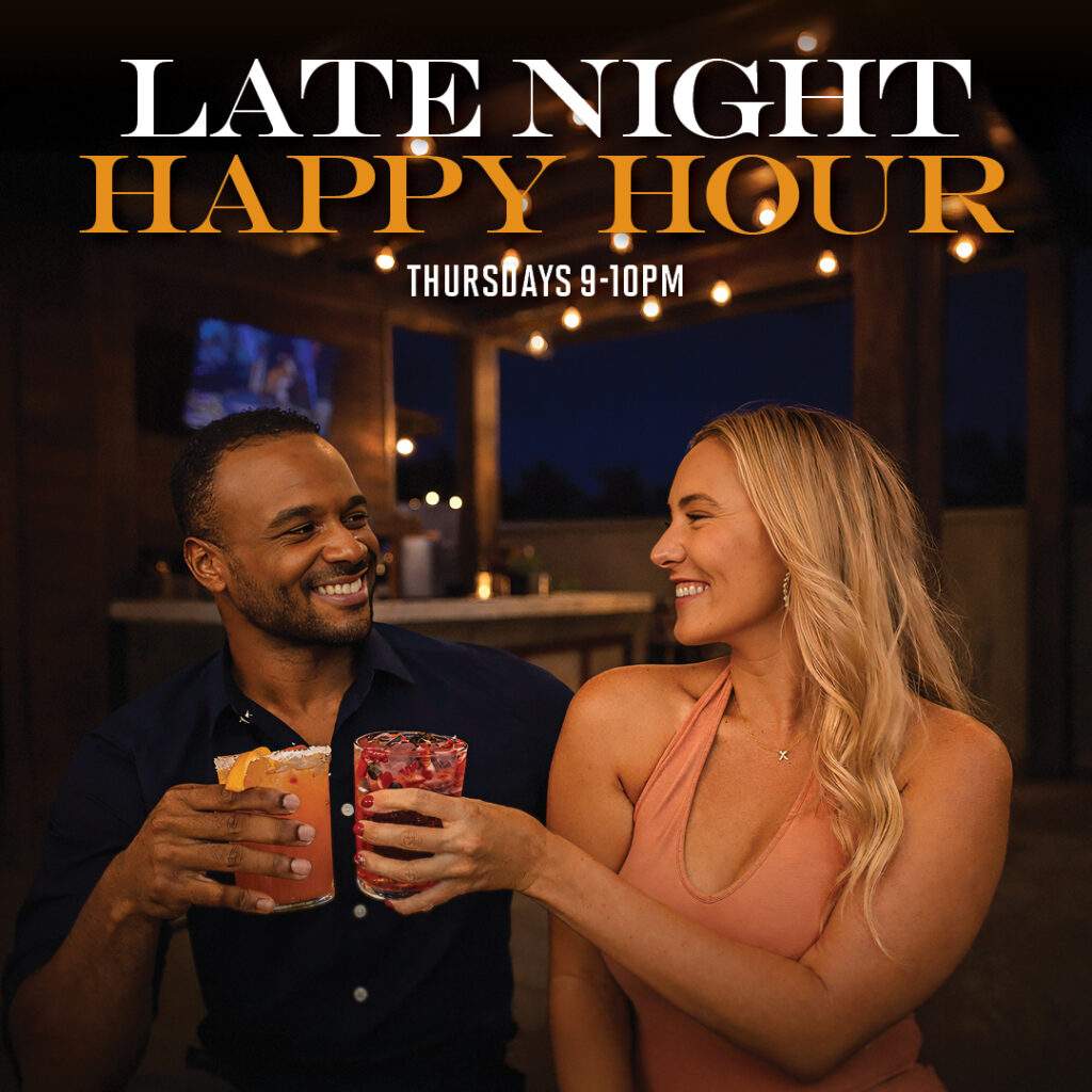 “Couple enjoying cocktails at Luna Lounge by Bulla during late night happy hour, Thursdays from 9–10 PM in a warm rooftop setting.”