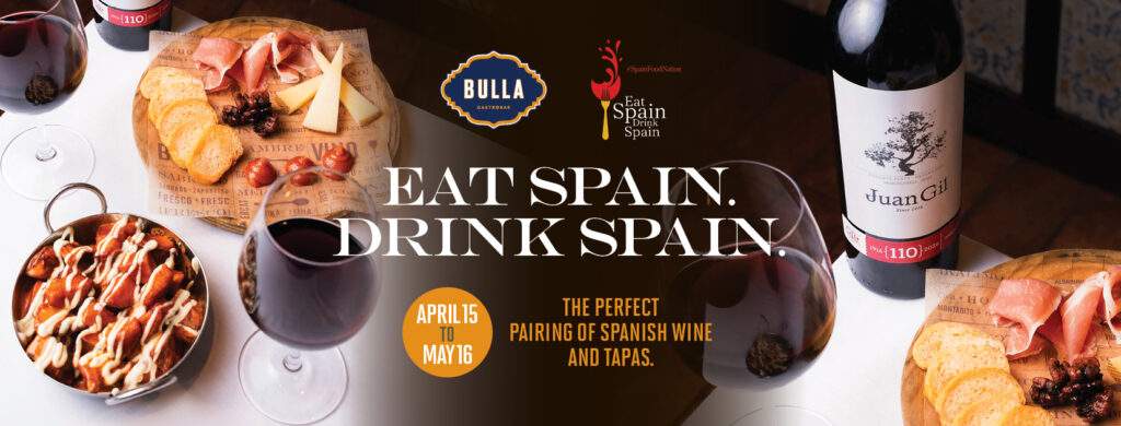 Spanish wine and tapas pairing at Bulla Gastrobar featuring Juan Gil wine, charcuterie board, and patatas bravas during Eat Spain Drink Spain promotion