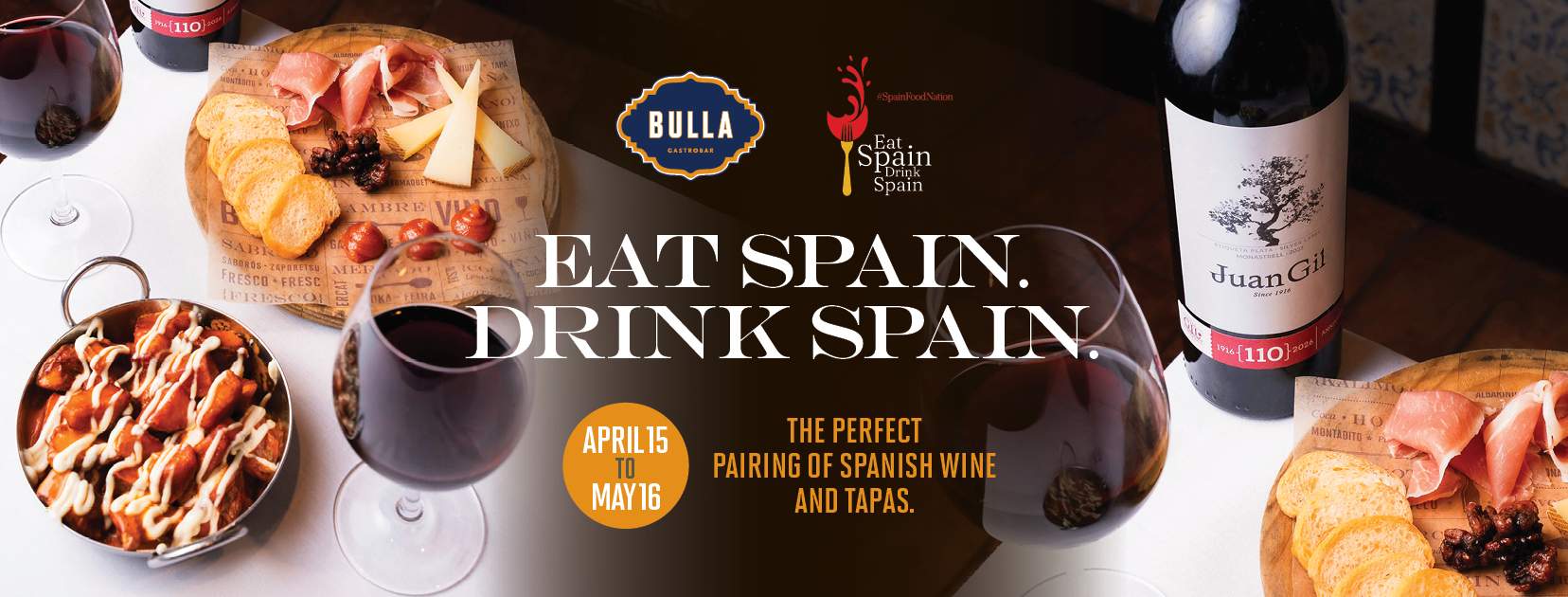 Spanish wine and tapas pairing at Bulla Gastrobar featuring Juan Gil wine, charcuterie board, and patatas bravas during Eat Spain Drink Spain promotion