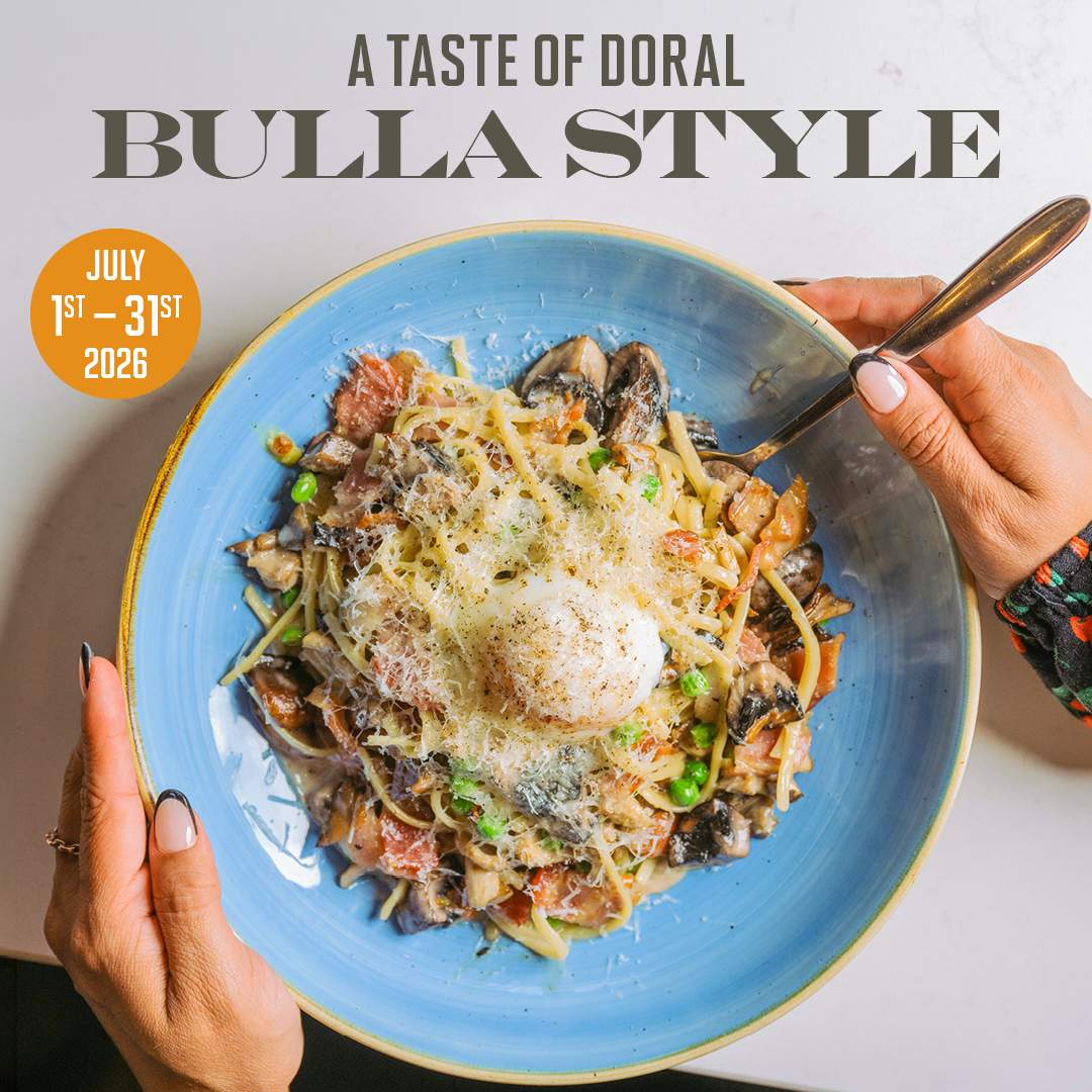 Overhead image of a pasta dish in a blue bowl with the text “A Taste of Doral, Bulla Style” and “July 1st–31st, 2026.”