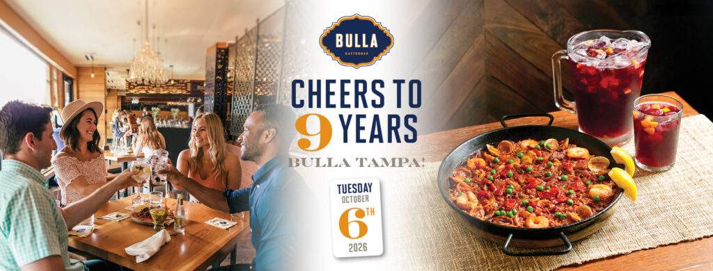 Bulla Tampa celebrates its 9th anniversary with a festive table featuring paella, sangría, and guests raising their glasses.